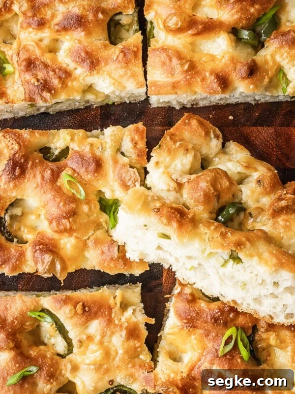 How to Make No-Knead White Bread at Home 9 Slices of cheddar jalapeno focaccia on a wooden board.