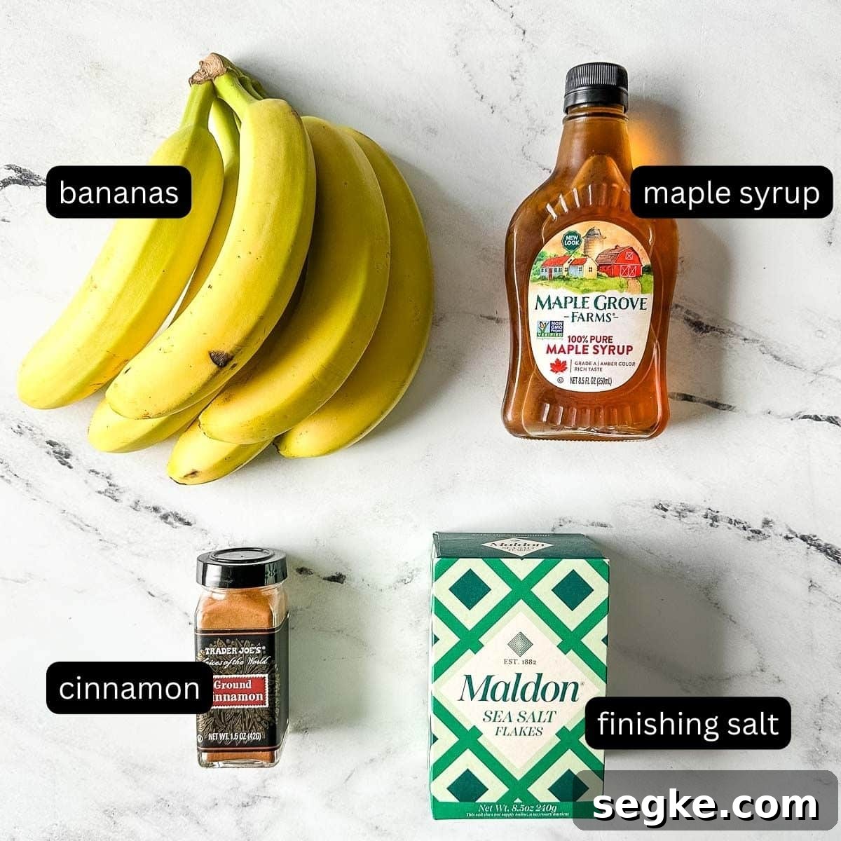 The labeled ingredients for air fryer bananas on a white marble counter.