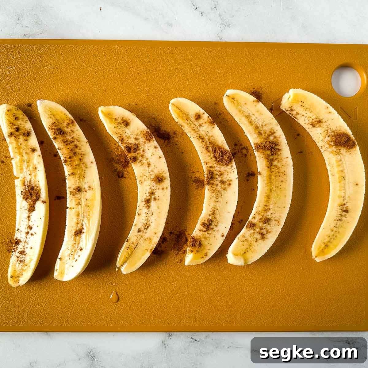 Halved bananas dusted with cinnamon.
