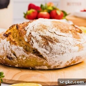 loaf of strawberry sourdough bread on wooden board.