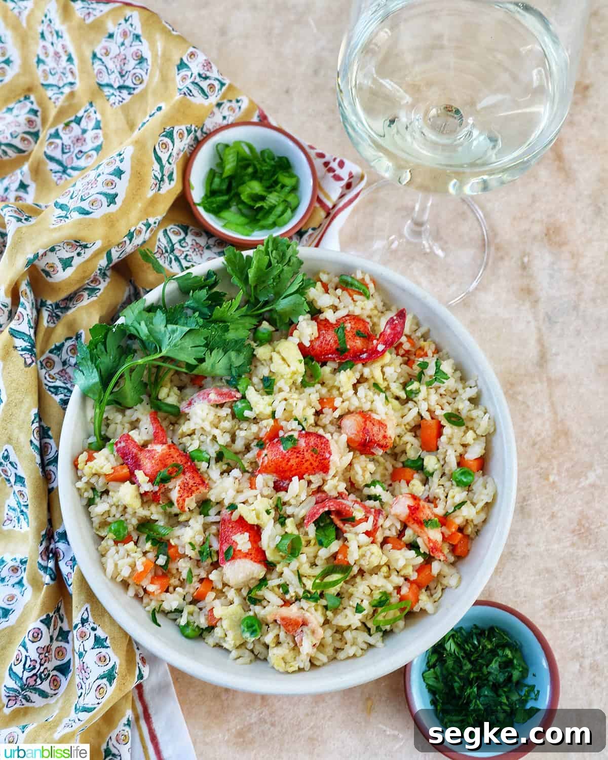 Garlic Butter Lobster Fried Rice 12 bowl of lobster fried rice with bowls of fresh herbs and a glass of white wine.