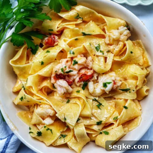 bowl of lobster pasta with side of parsley.