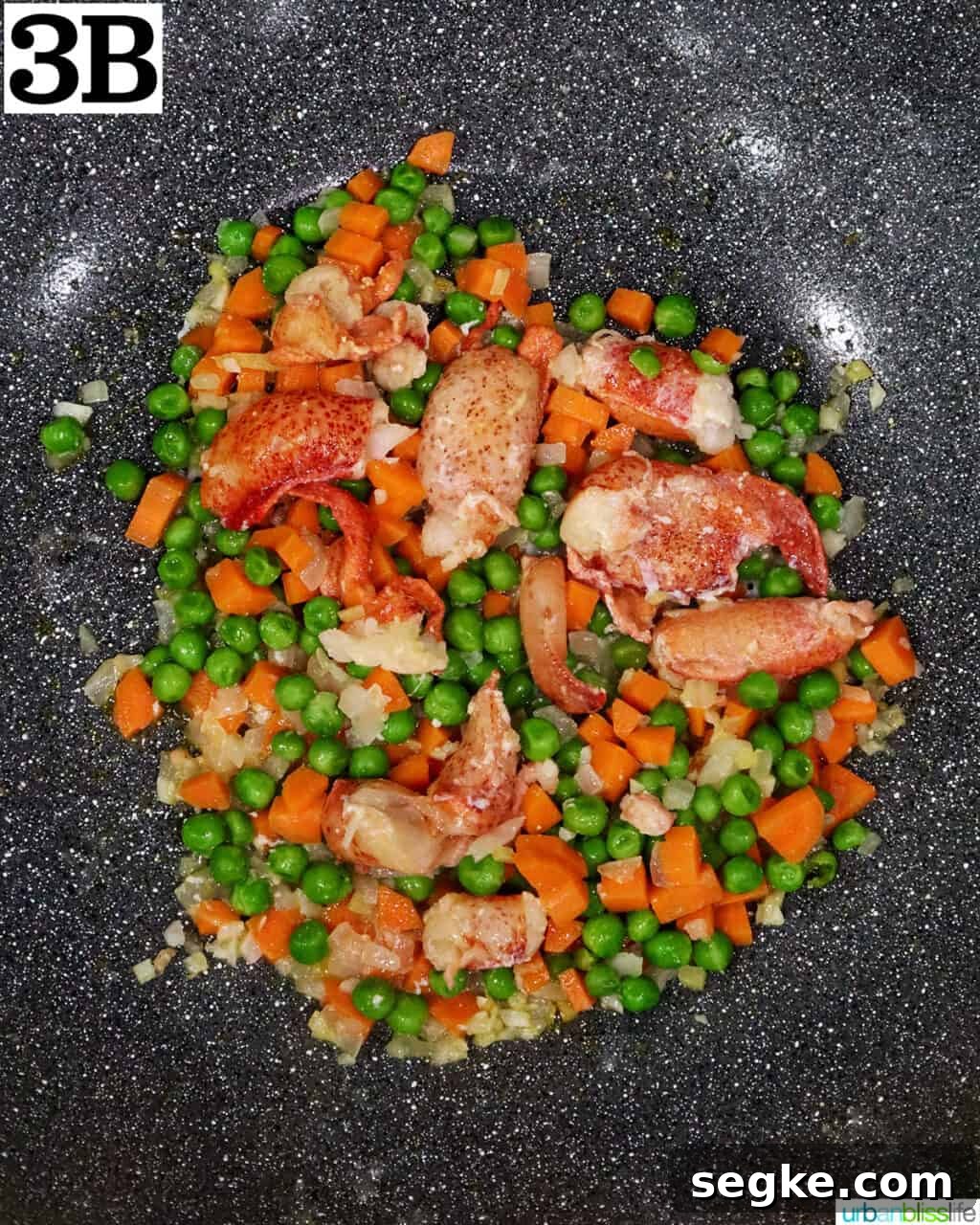 Garlic Butter Lobster Fried Rice 9 lobster meat with vegetables cooking in a wok.