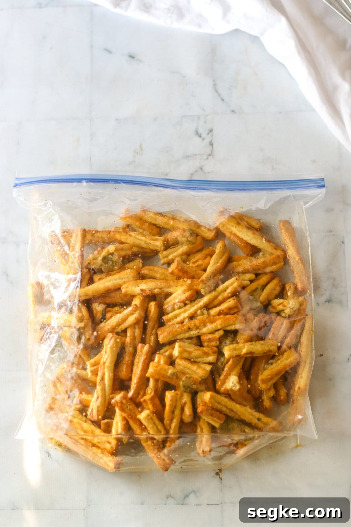 Copycat Dot's Seasoned Pretzels Recipe 4 Shaking the ingredients to coat.