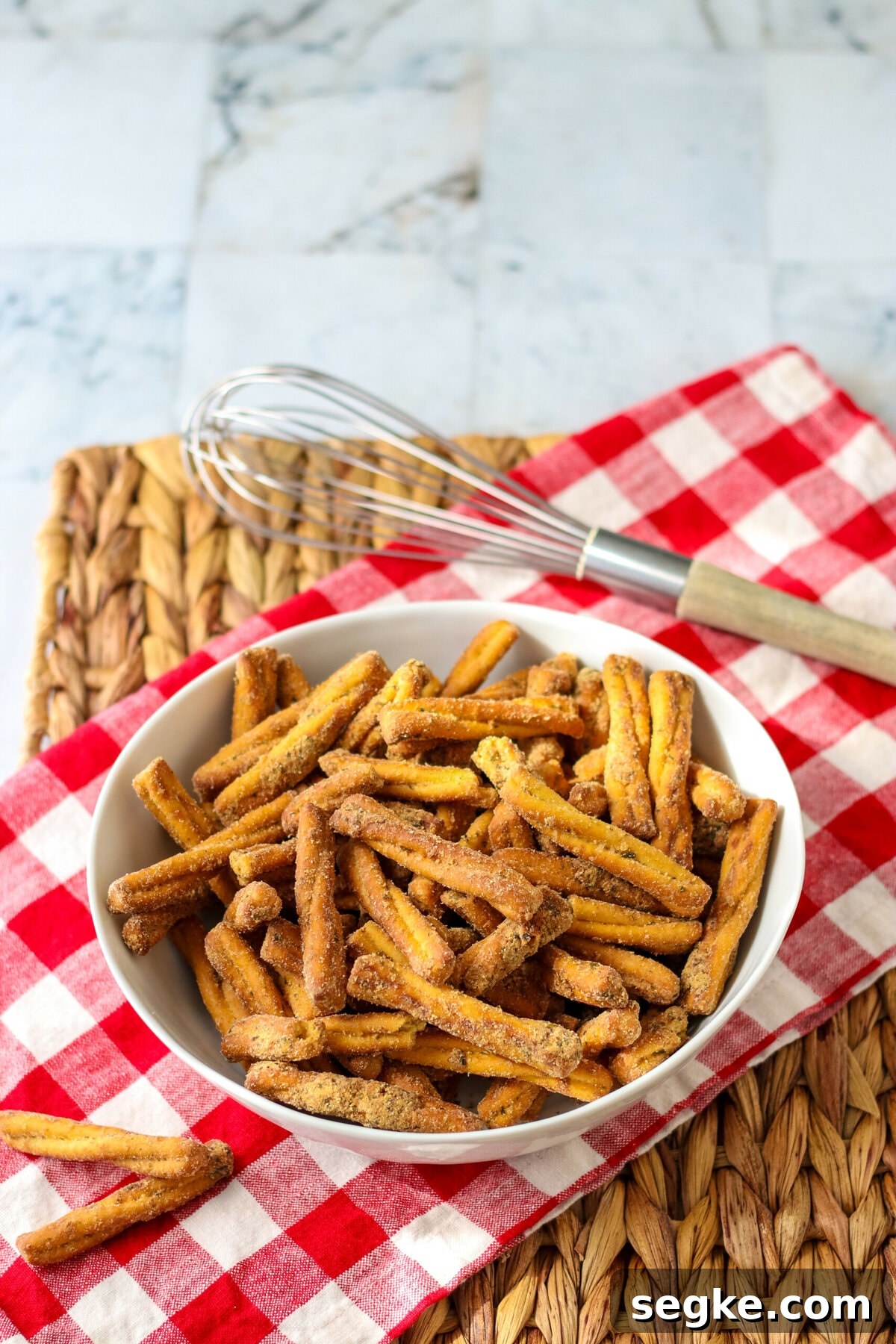 Copycat Dot's Seasoned Pretzels Recipe 6 Seasoned Pretzels on a red and white cloth.