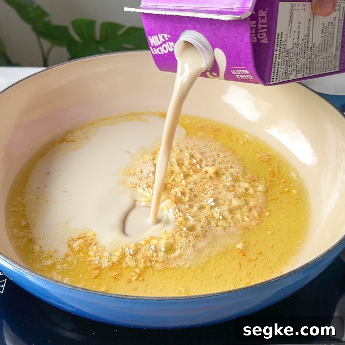 Creamy Vegan Alfredo Sauce for Fettuccine 4 Sauté garlic then add milk