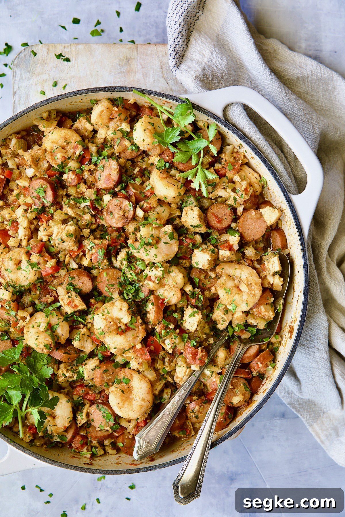 Low-Carb Jambalaya with Chicken, Shrimp and Sausage with serving utensils.