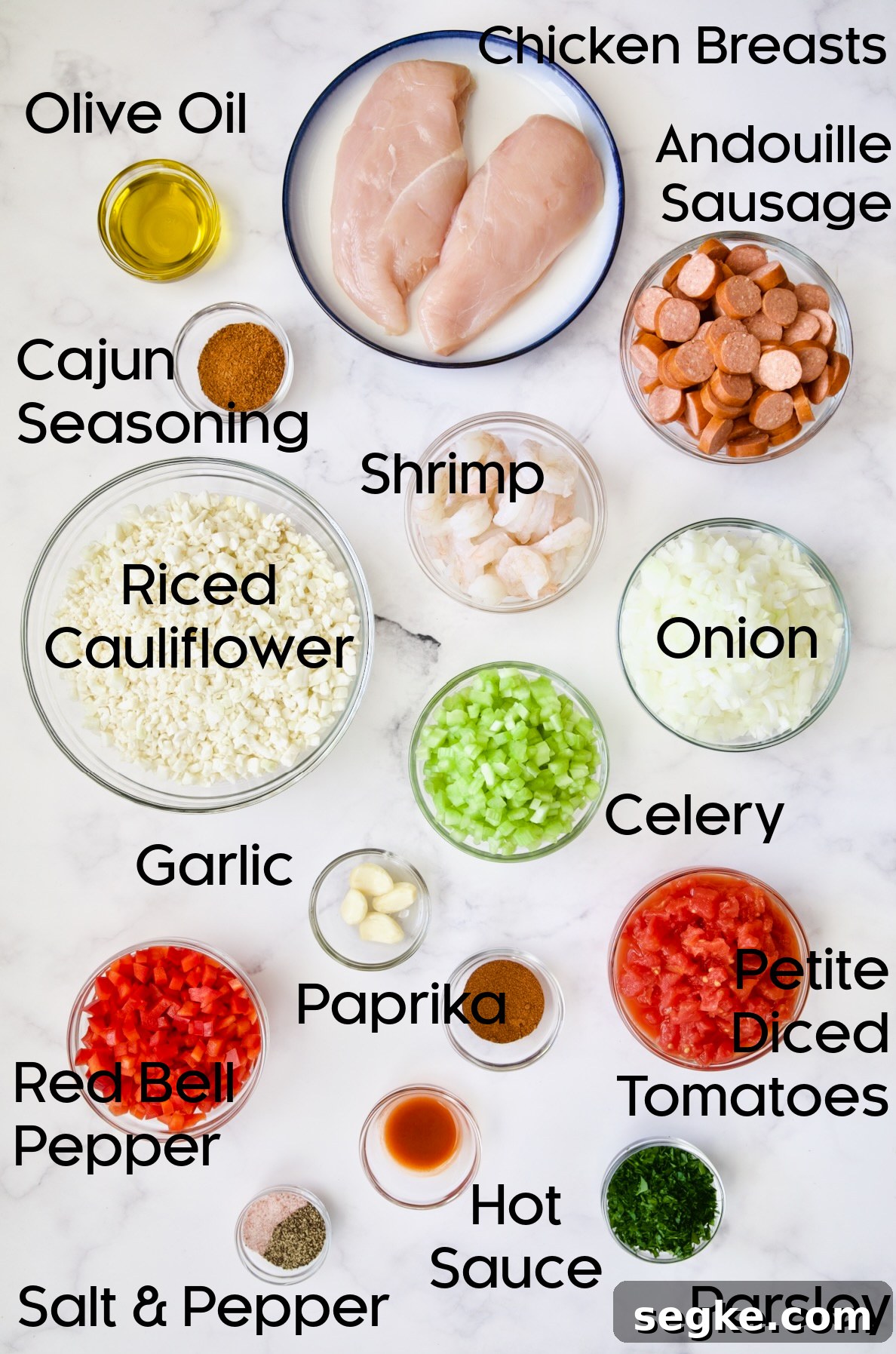 Ingredients for Low-Carb Jambalaya with Chicken Shrimp and Sausage in glass bowls.