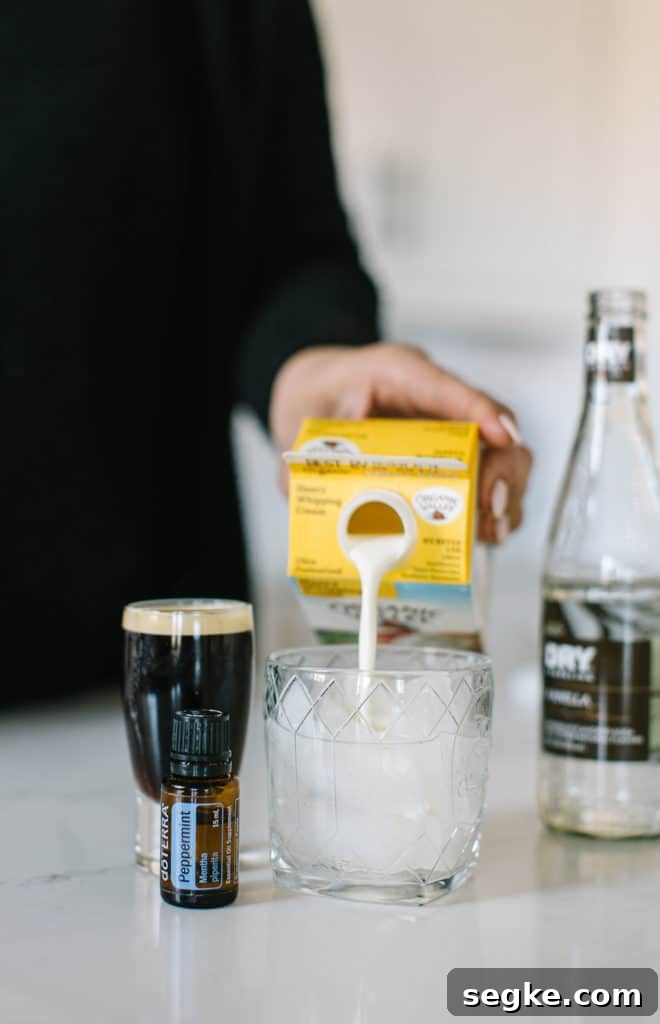 White Russian mocktail cream being poured