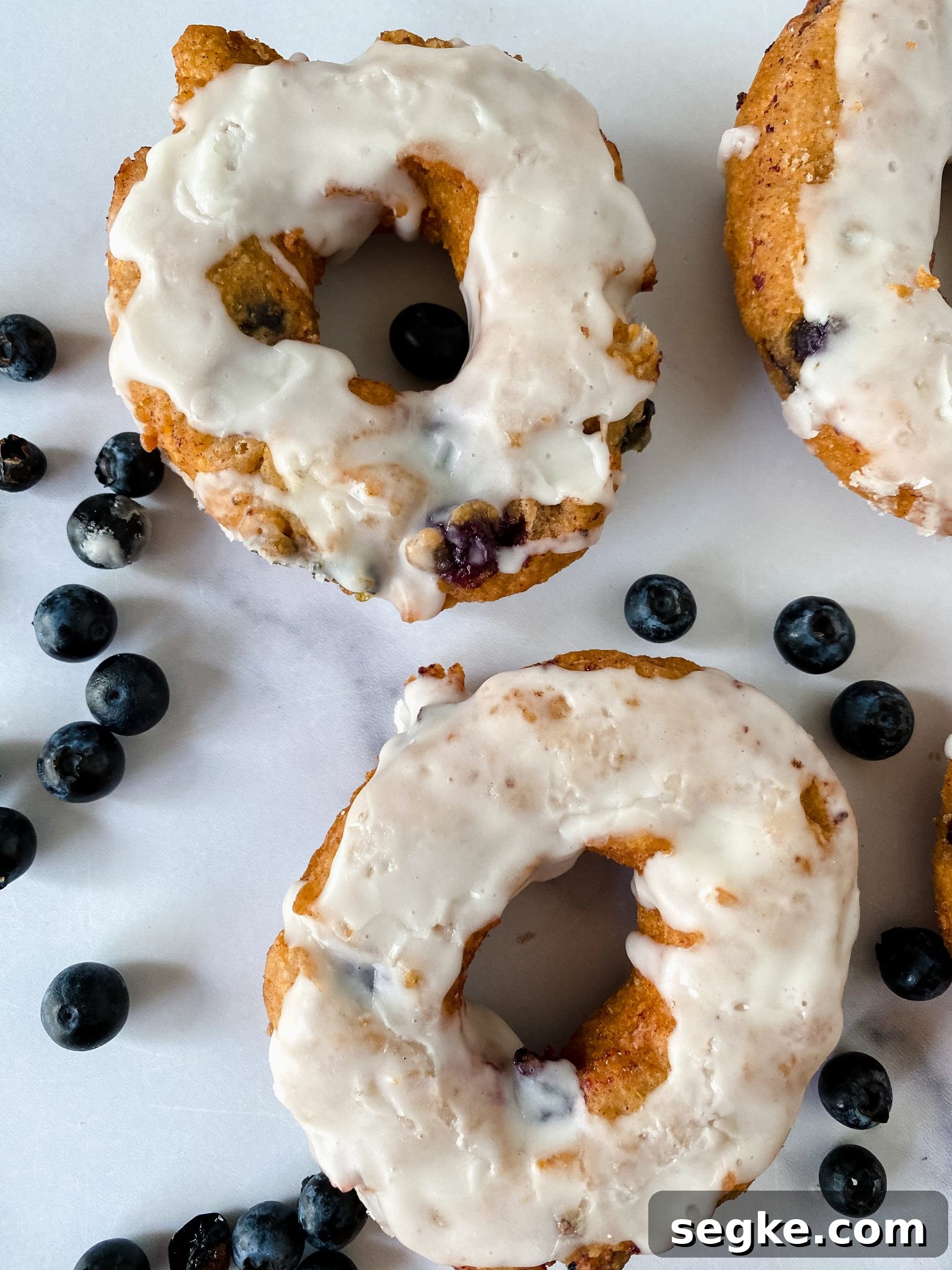 How to Make Homemade Fried Glazed Blueberry Donuts 12 Top down view of two glazed donuts