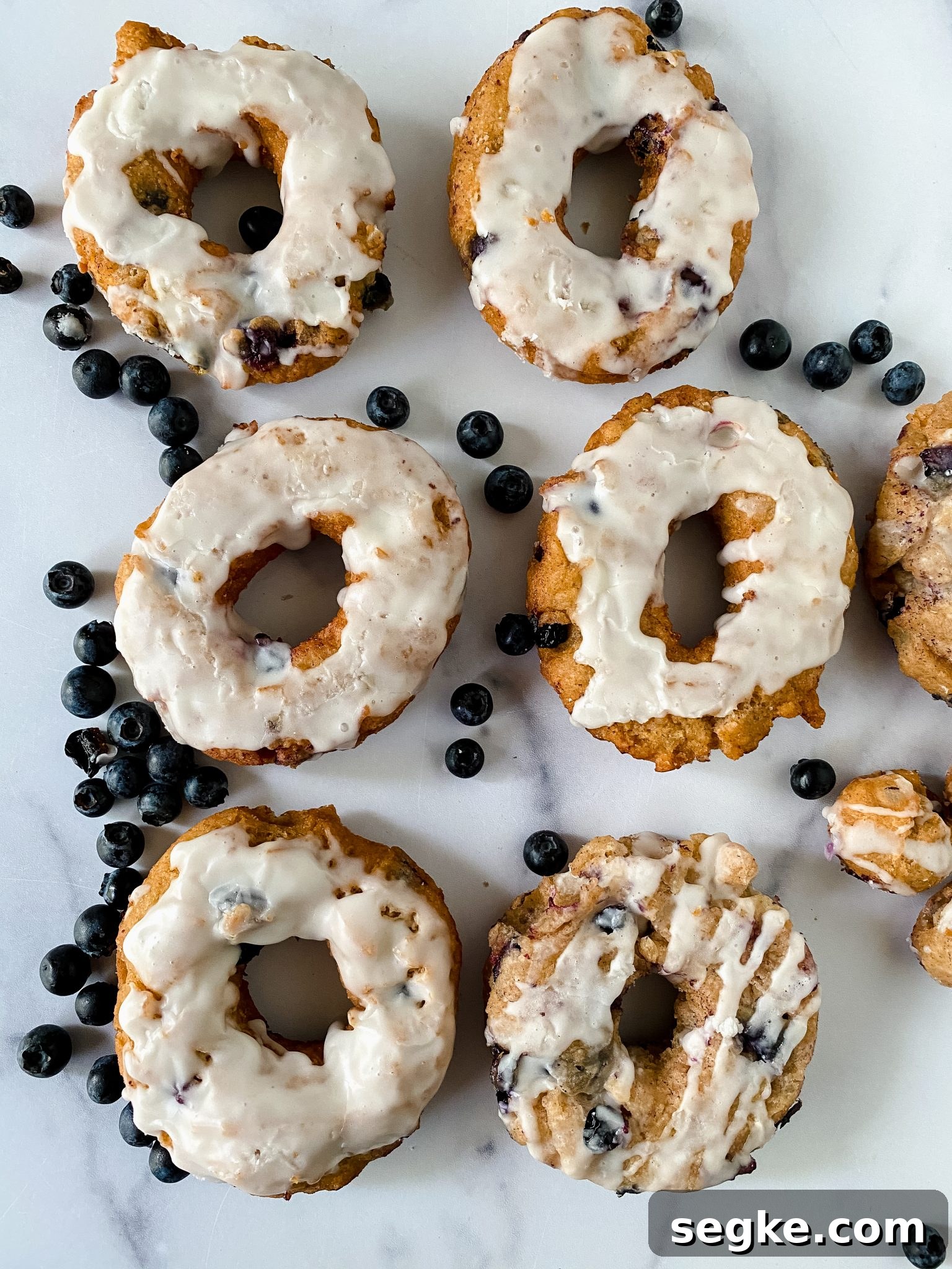 How to Make Homemade Fried Glazed Blueberry Donuts 14 Top down view of blueberry glazed donuts.