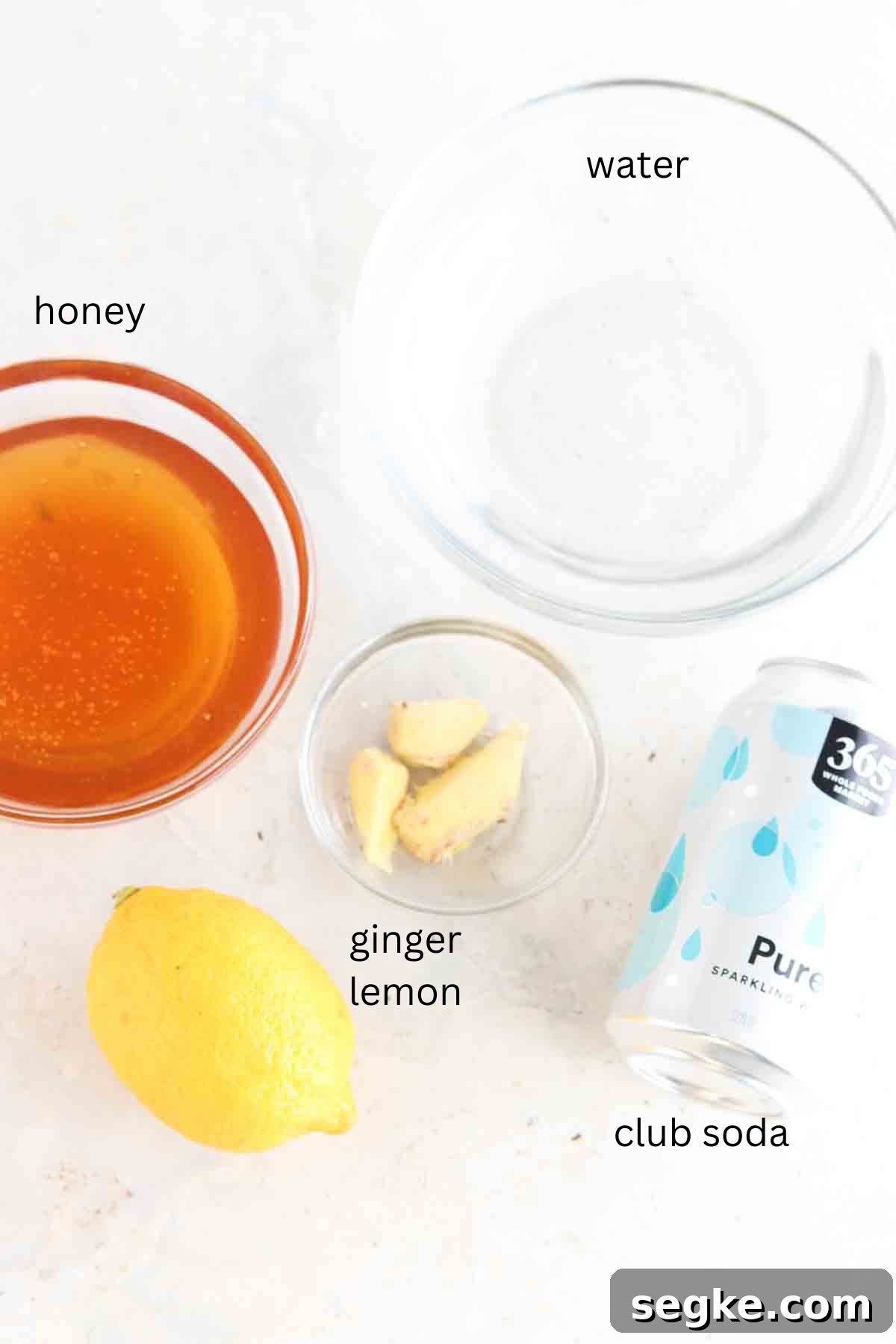 Ginger mocktail ingredients laid out on the counter in small glass bowls.