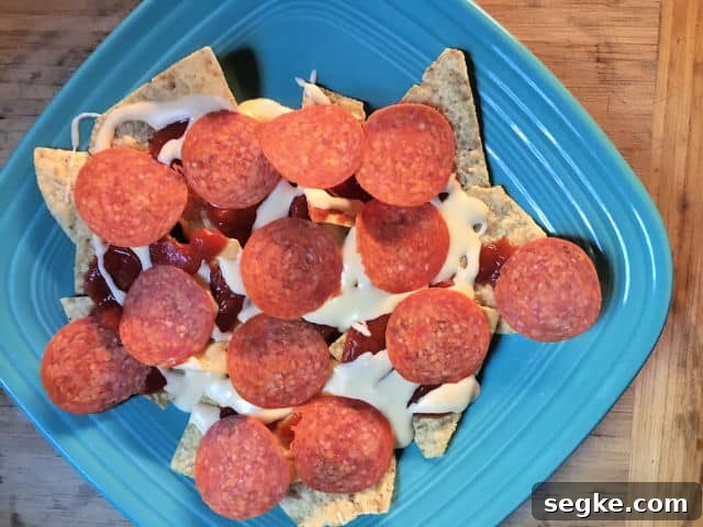 pepperonis on chips on blue plate