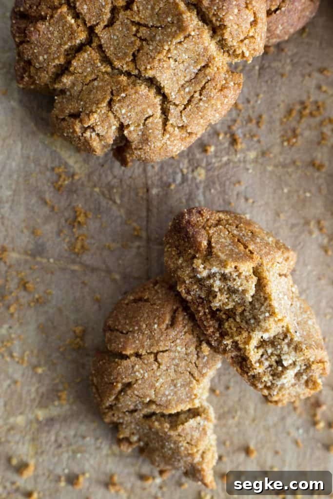 Homemade Gluten-Free Ginger Cookies 3 broken ginger biscuit on a wooden board