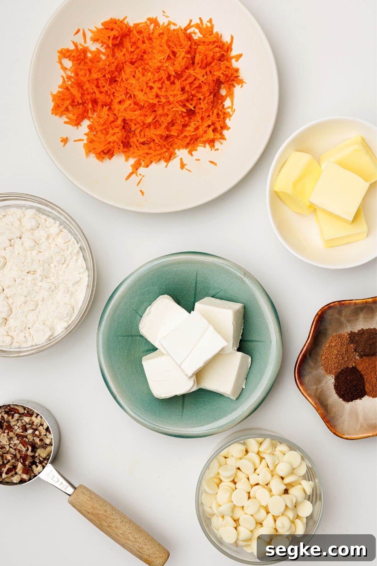No Bake Keto Carrot Cake Protein Bites 3 Overhead flat lay of grated carrots, cream cheese, butter, protein powder, spices, white chocolate chips, and pecans