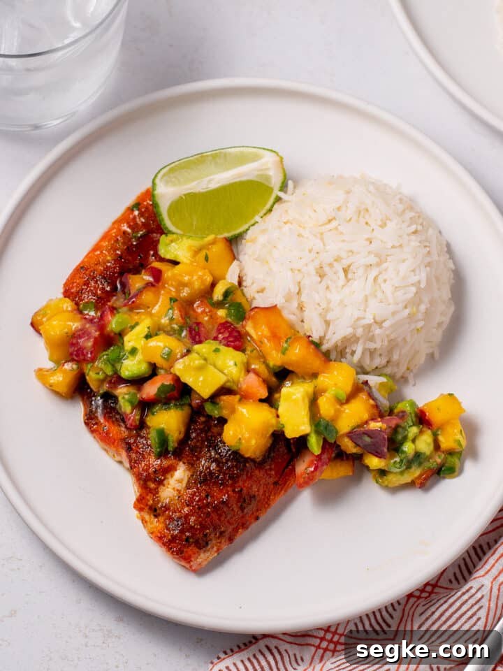 How to Make Fluffy Coconut Basmati Rice 7 plate with mound of coconut basmati rice, piece of seasoned salmon and dollop of nectarine pico de gallo