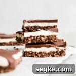 Three layered bars stacked on a wire rack.