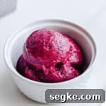 Pink sorbet in a small white bowl.