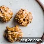 Three honey almond bites on a small rustic plate.