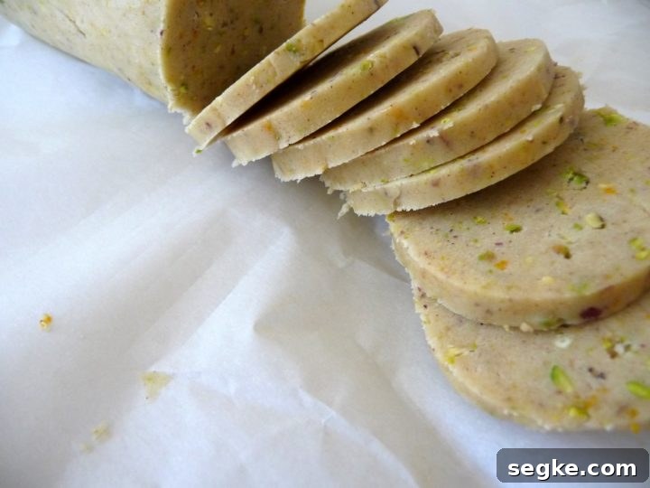 a roll of cannoli cookie dough being sliced