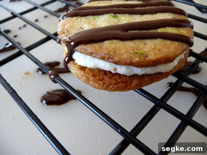 photo of a cannoli cookie on a cookie cooling rack after being drizzled with chocolate