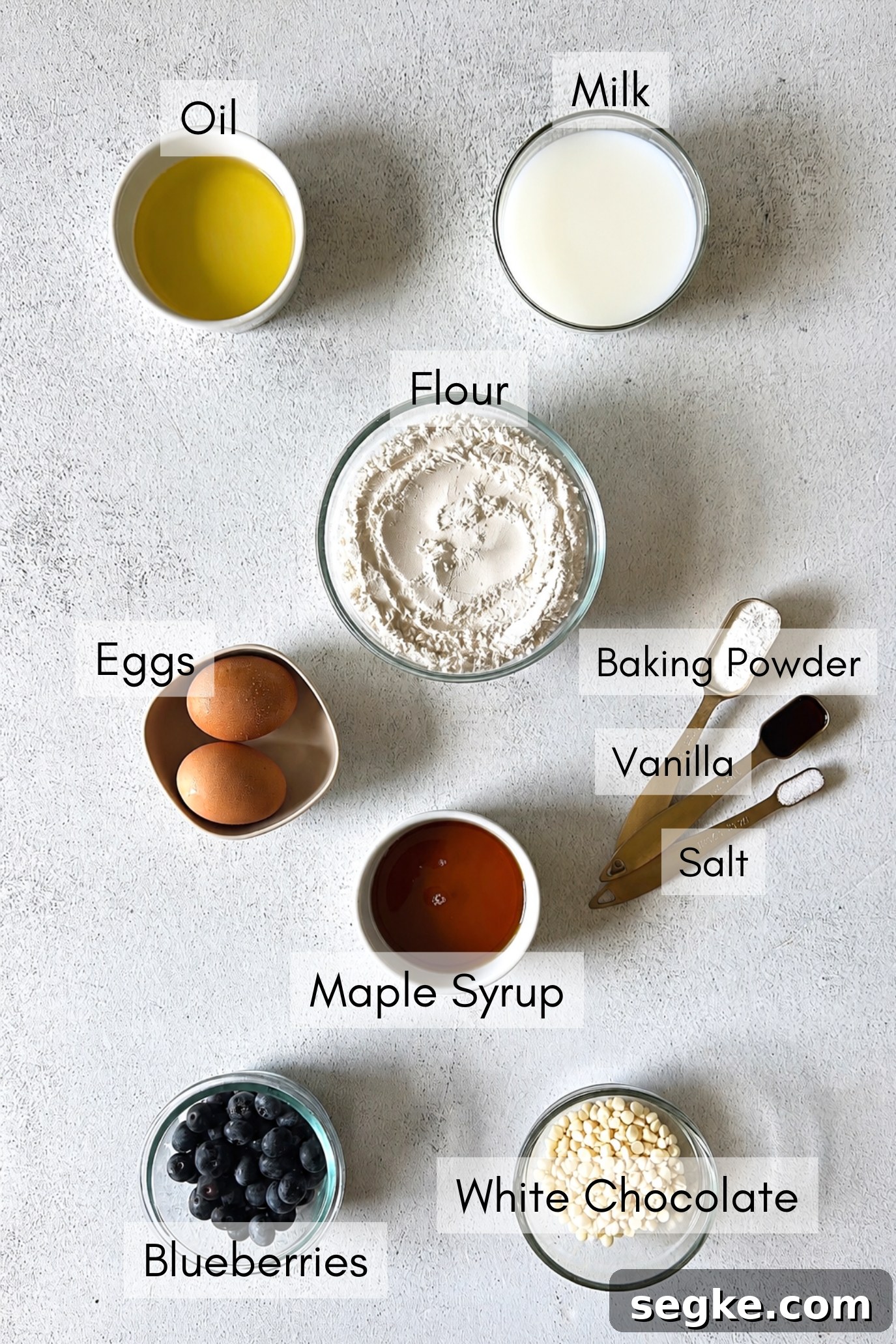 Ingredients to make white chocolate blueberry muffins.