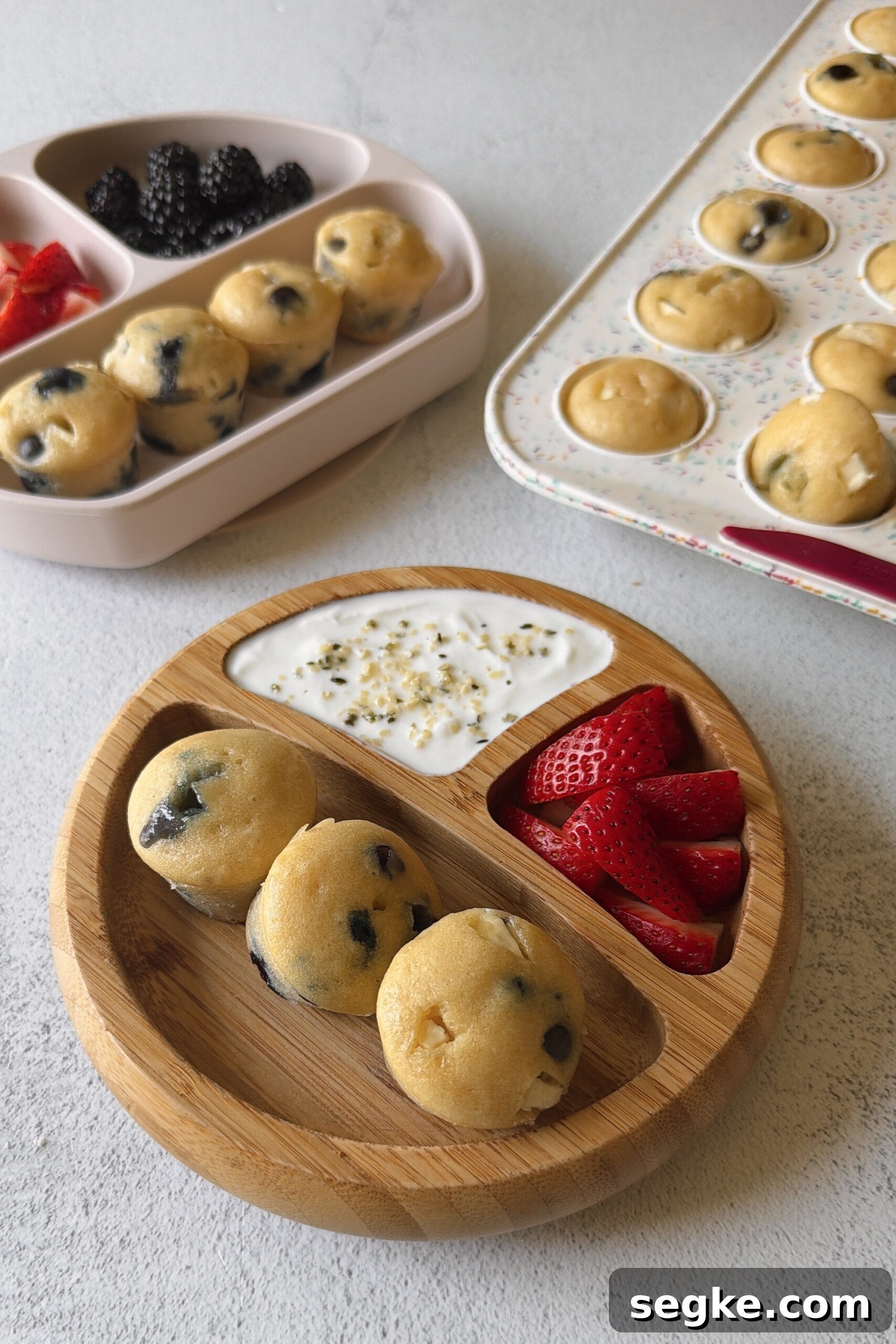 Blueberry and white chocolate muffins served with berries and yogurt.