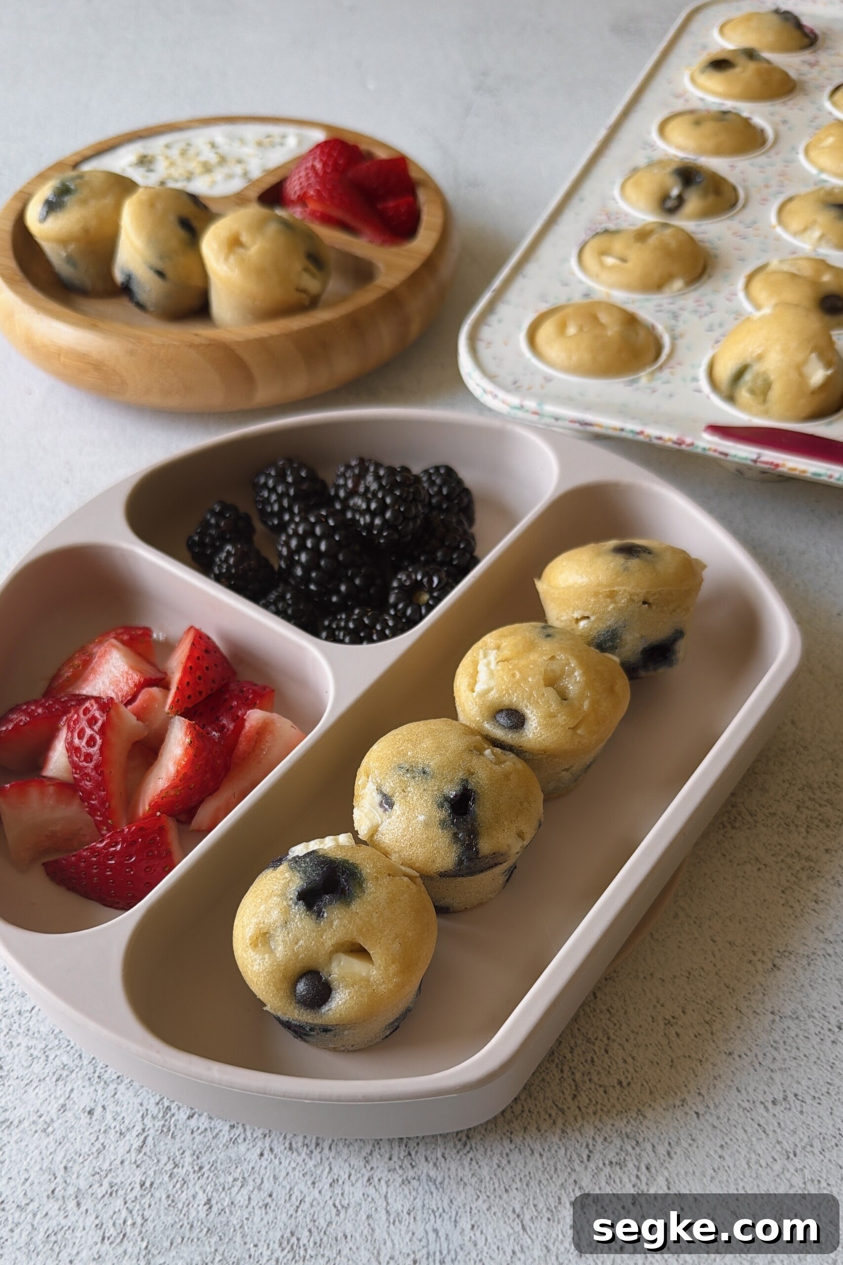 Blueberry and white chocolate muffins served with berries and yogurt.