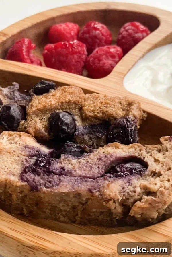 Blueberry French toast bake served with a side of yogurt and raspberries
