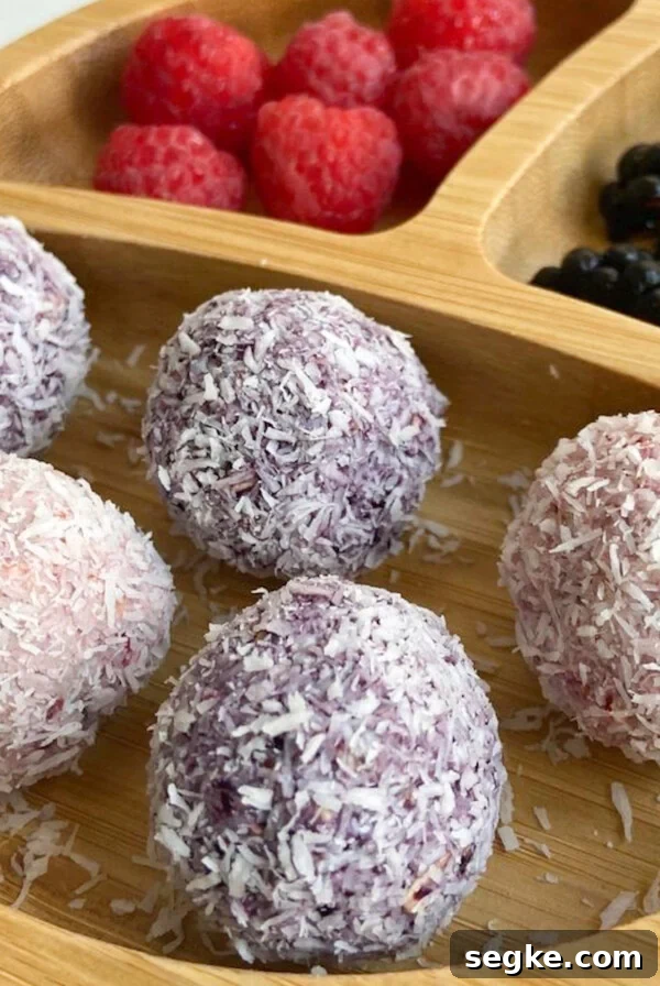 Berry bliss balls served with raspberries and blackberries