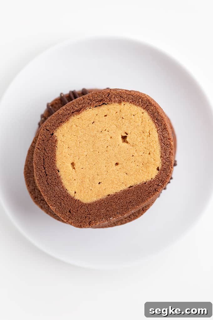 Overhead image of stacked buckeye cookies on a white plate on a white surface