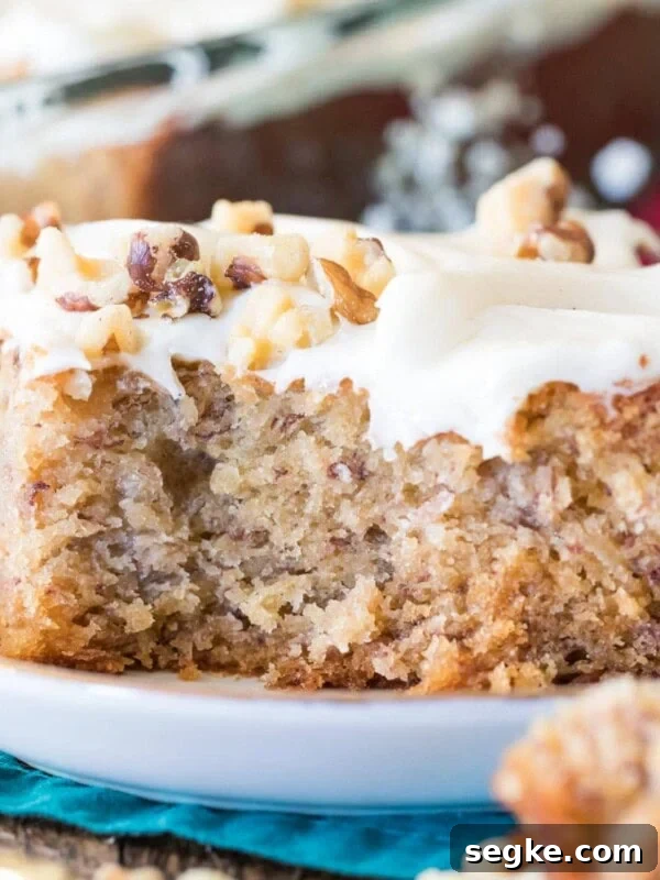 Banana cake with bite taken out on a white plate.