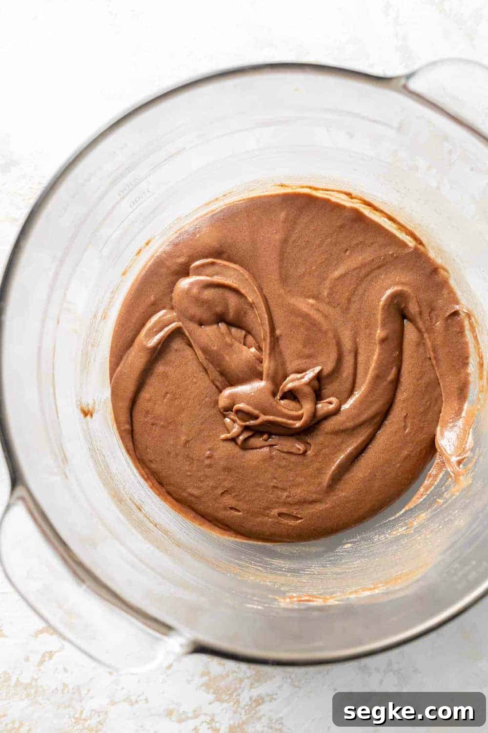 Fudgy Pumpkin Brownies with Cinnamon Chocolate Swirl 3 Brownie batter in a glass bowl, ready to be made into pumpkin brownies