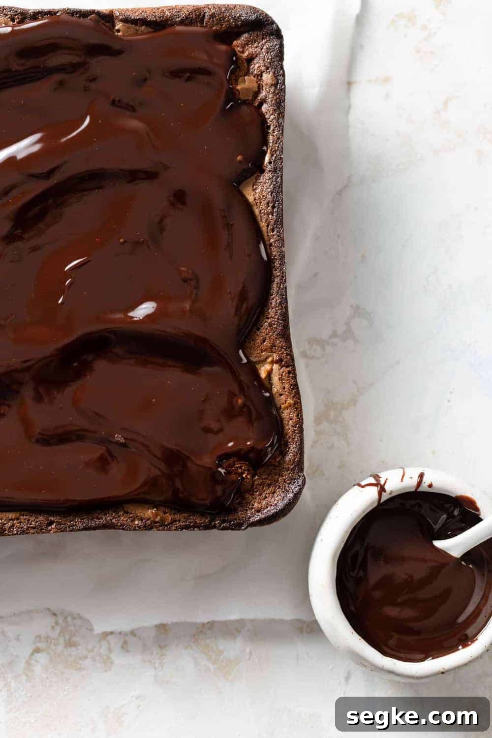 Fudgy Pumpkin Brownies with Cinnamon Chocolate Swirl 6 Chocolate ganache next to pumpkin brownies recently topped with ganache