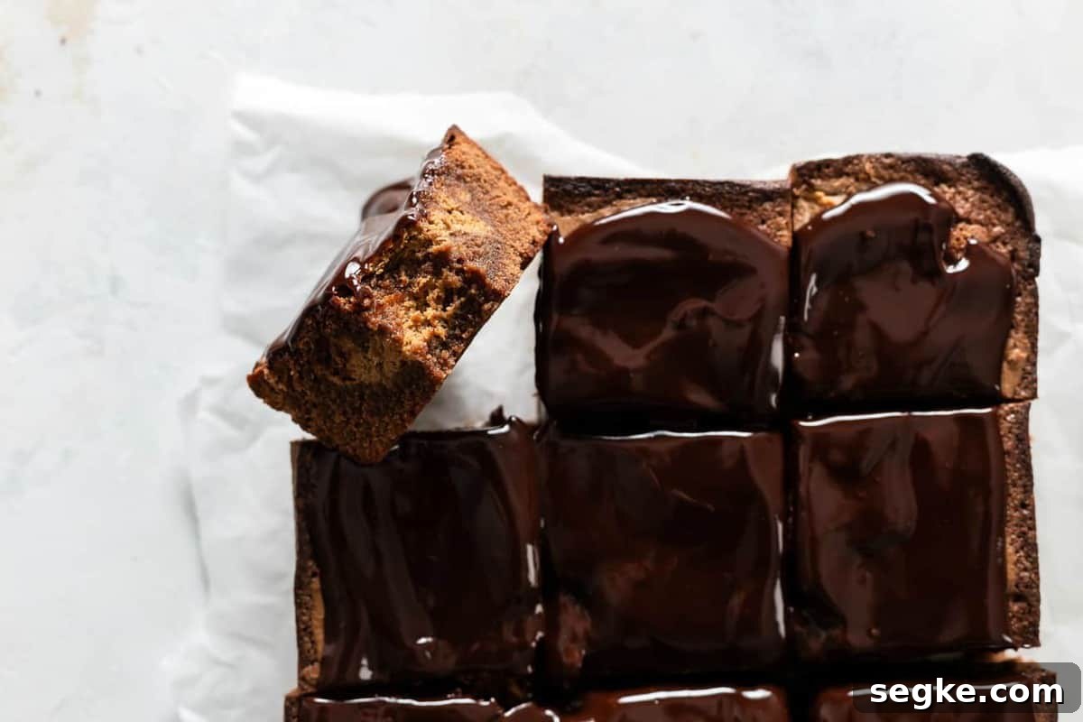 Fudgy Pumpkin Brownies with Cinnamon Chocolate Swirl 8 Pumpkin brownies sliced on a piece of parchment paper