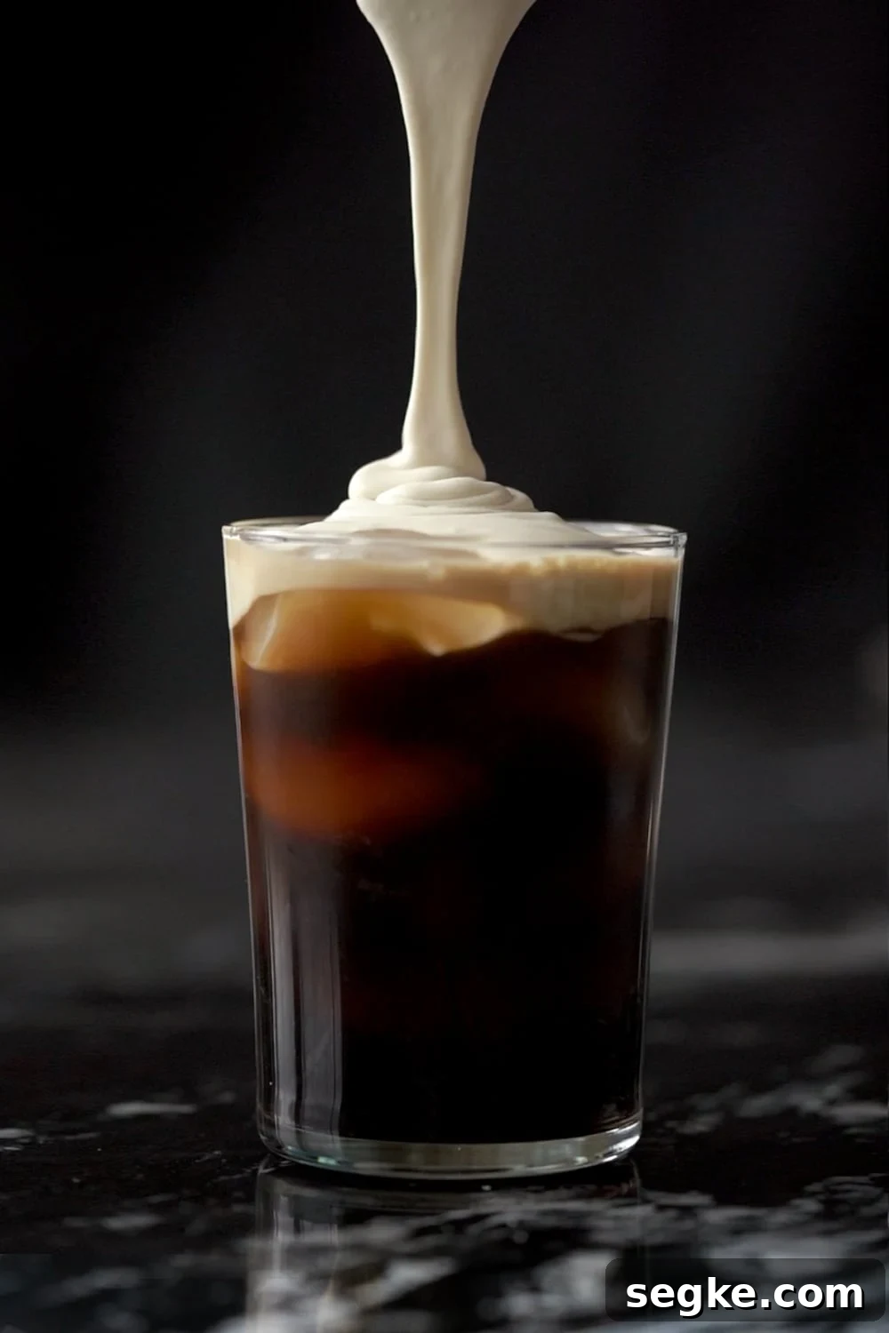 Keto Salted Caramel Cream Cold Brew: Starbucks Copycat 2 Pouring the salted caramel cream onto a tall glass with cold brew and ice