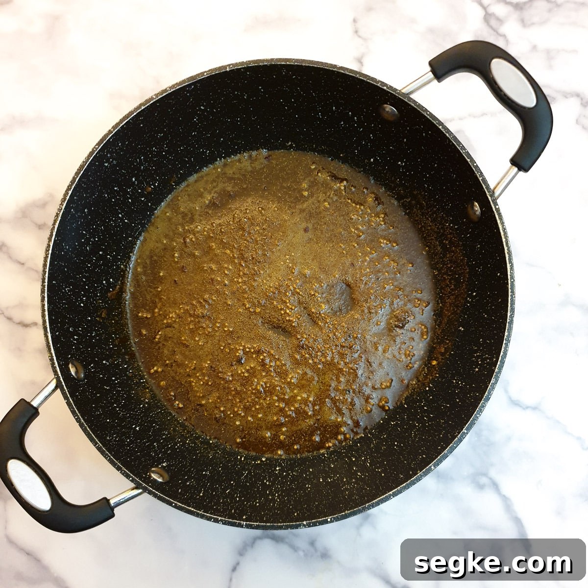 Spices frying in a frying pan.