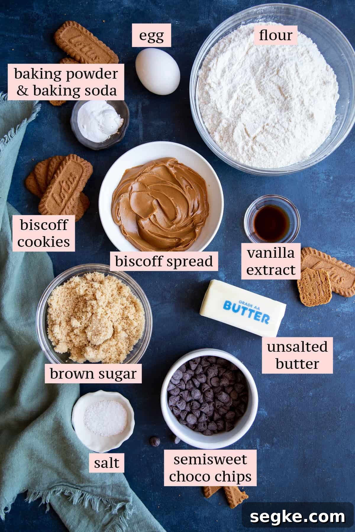 How to Make Chewy Biscoff Chocolate Chip Cookies 3 Ingredients for Biscoff chocolate chip cookies on a dark blue surface.