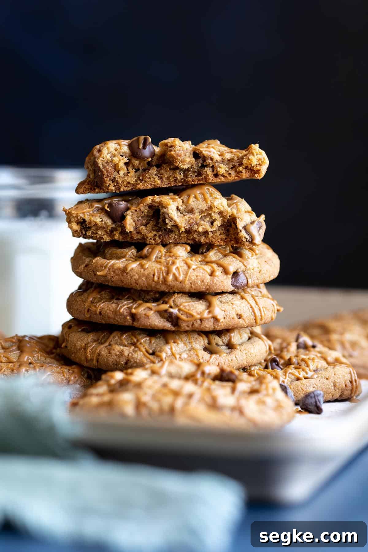 How to Make Chewy Biscoff Chocolate Chip Cookies 4 A stack of Biscoff chocolate chip cookies, the top ones are broken in halves.