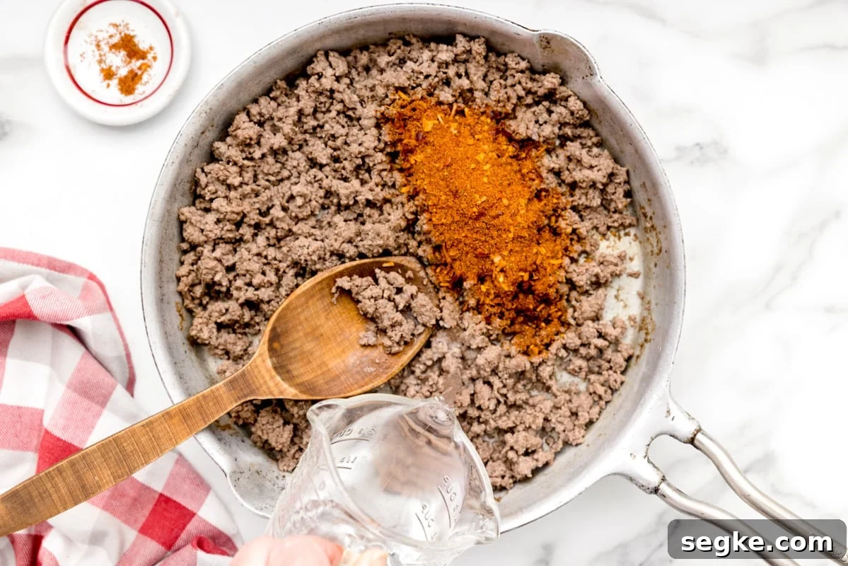 Walking Tacos: Portable Taco Cups for Parties and Tailgates 2 Taco seasoned ground beef in a skillet.