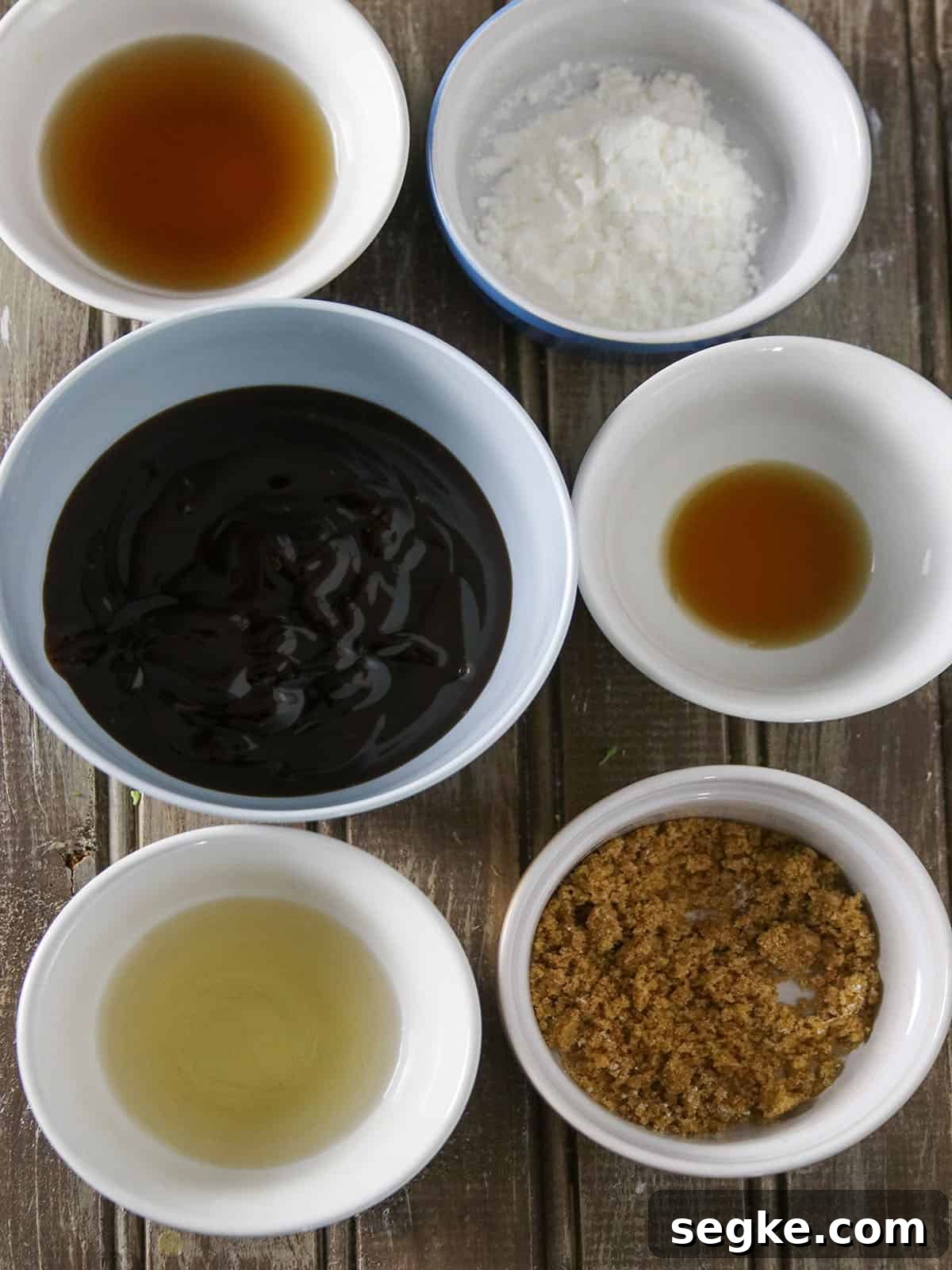 soy sauce, sesame oil, oyster sauce, cornstarch, rice vinegar, Chinese cooking wine in white small bowls