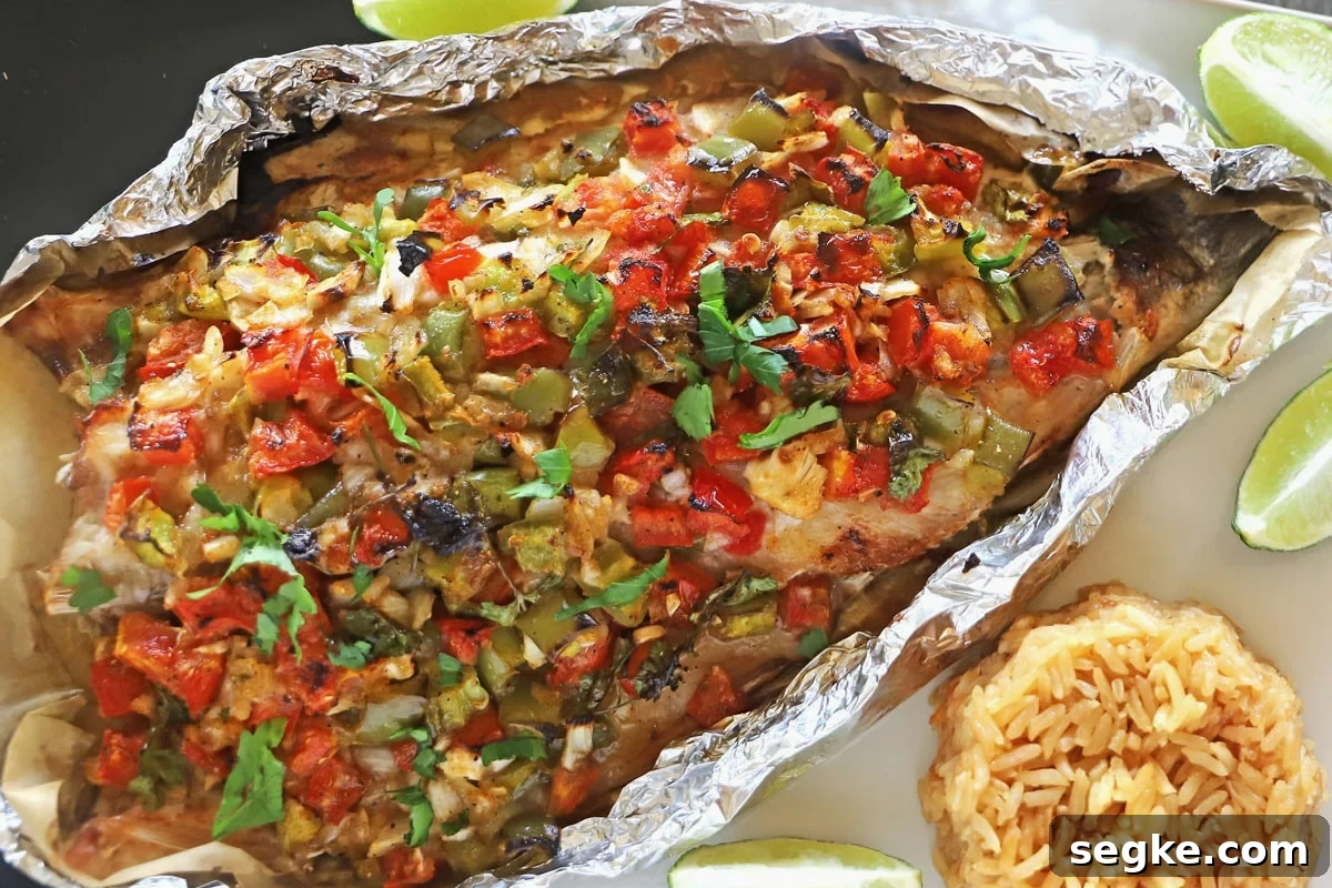 An overhead image of a sea bass on a serving platter with vegetables and rice.