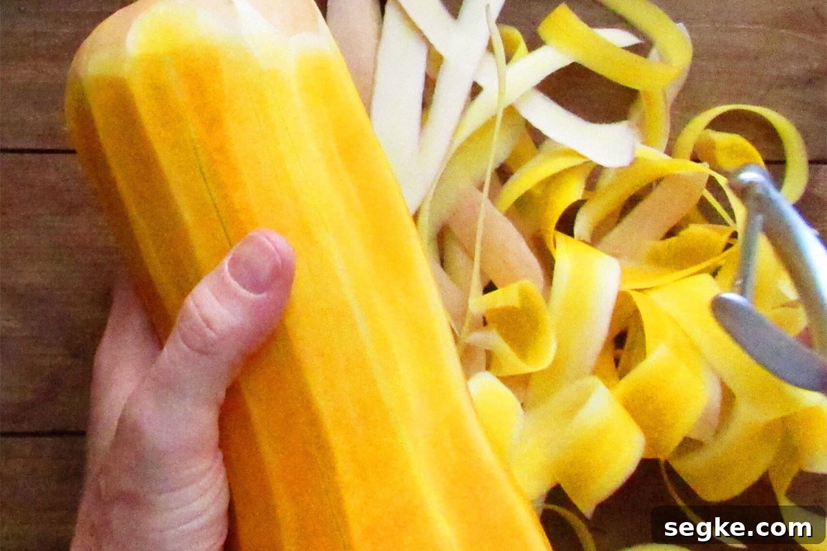 Woman peeling butternut squash.