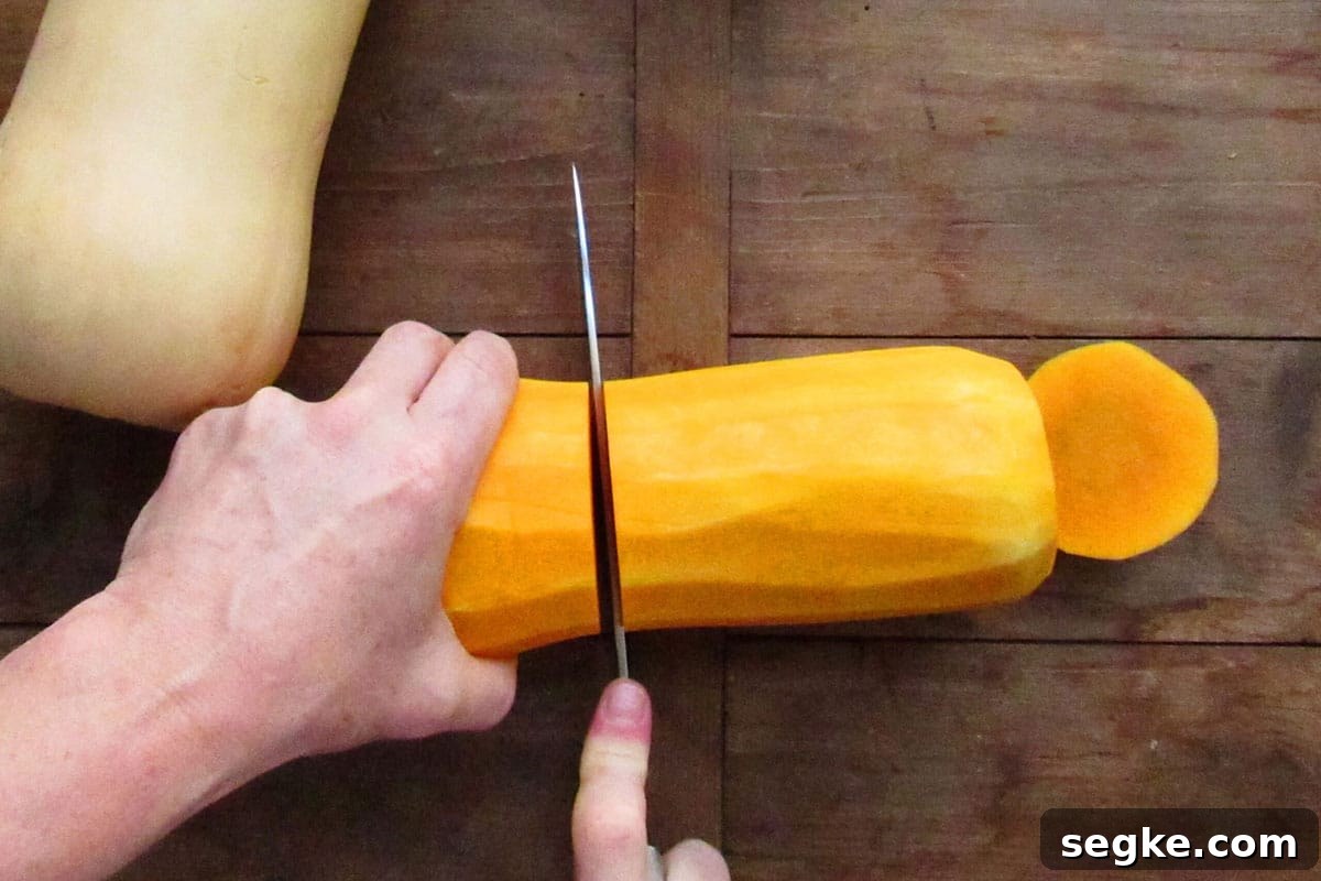 Slicing butternut squash in half.