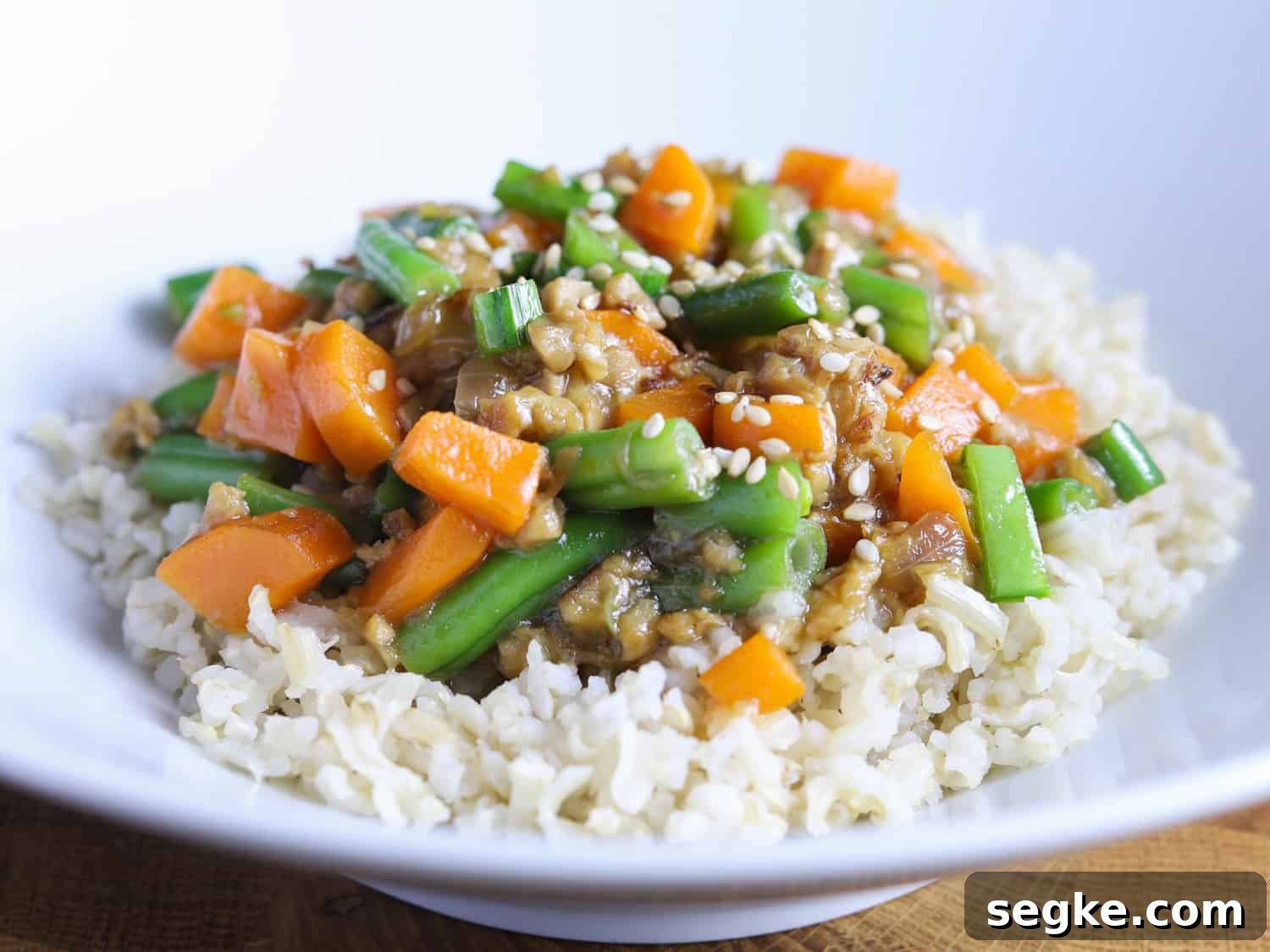 photo of a bowl of vegan chinese green beans and tempeh adapted for children (with carrot)