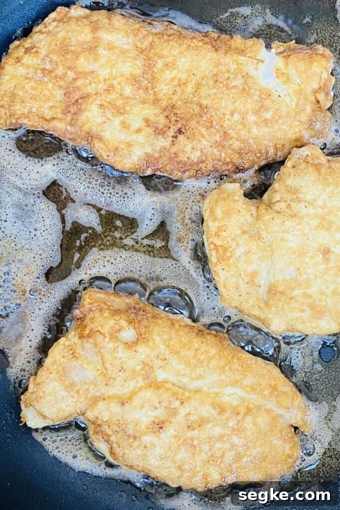 Frying battered chicken in oil.