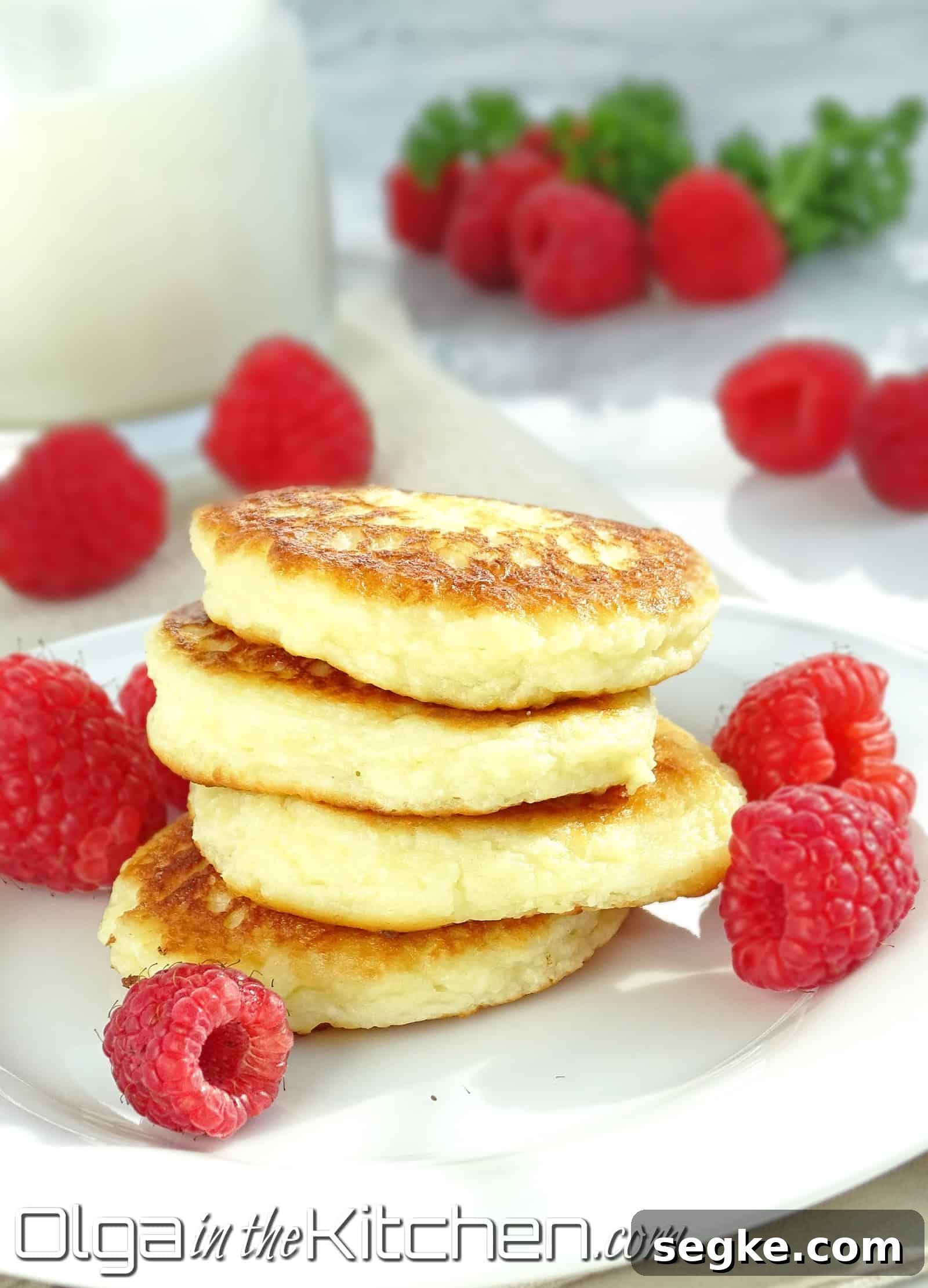 Close up of sirniki cheese pancakes on a plate.