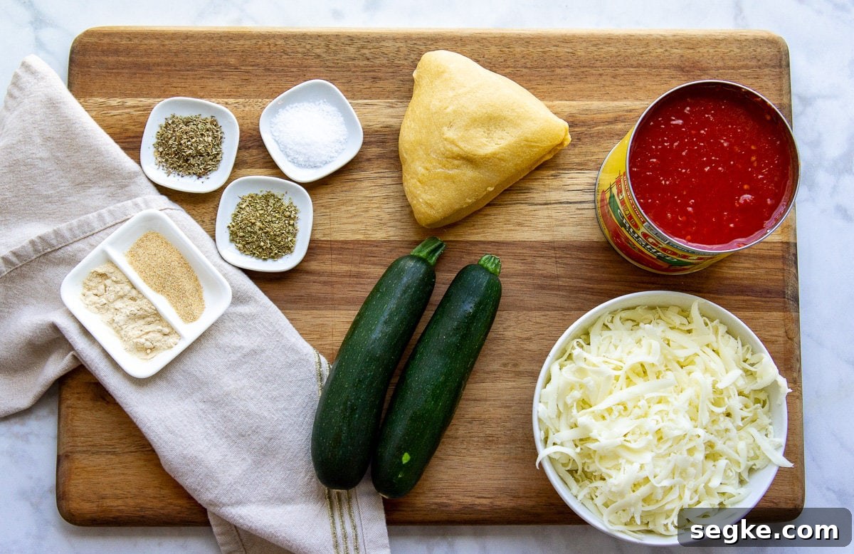 Ingredients to make zucchini lasagna with noodles including spices, tomato sauce, and cheese.