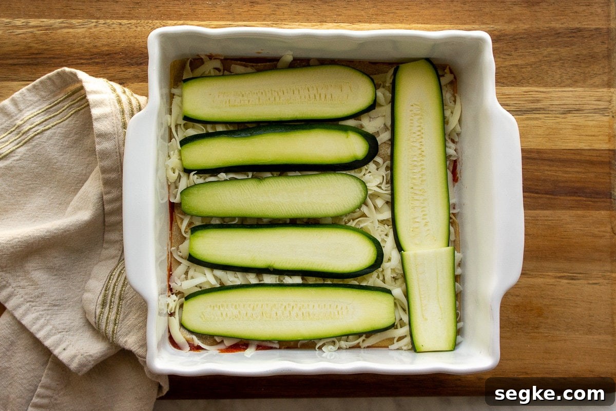 The zucchini layer in a lasagna with cheese.