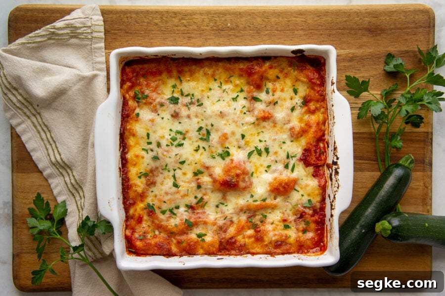 A cheesy lasagna in an 8x8 casserole dish.